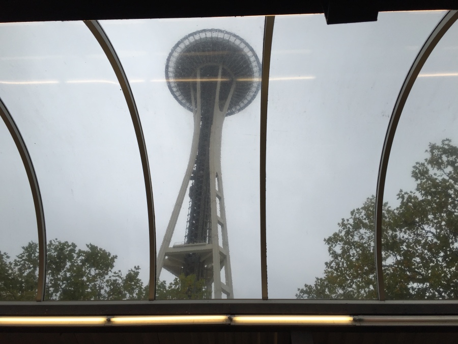 The Seattle Space Needle is visible through the monorail terminal skylights.